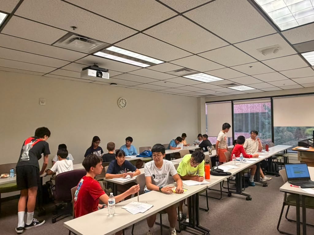 Students collaborating in small groups during 2026 debate workshops